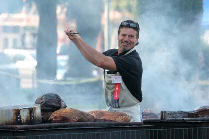 Melania Mahoney Joe Castanera prepares to spear and turn the ox as the heat rises over the grill.