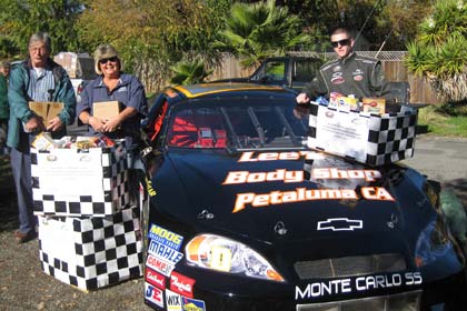 John Cardinale F.I.S.H. coordinator Sherman Biefelt, Infineon Raceway employee Jerry Wheeler and driver P.J. Pedroncelli unload more than 2,500 pounds of food to F.I.S.H. on behalf of the raceway on Monday.